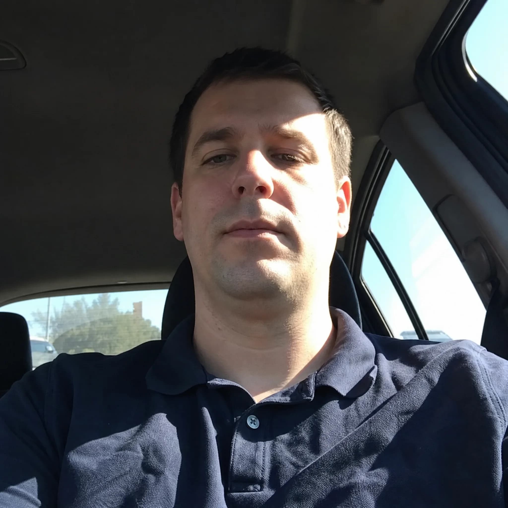 Before and after comparison of LinkedIn professional headshot transformation from car selfie - before